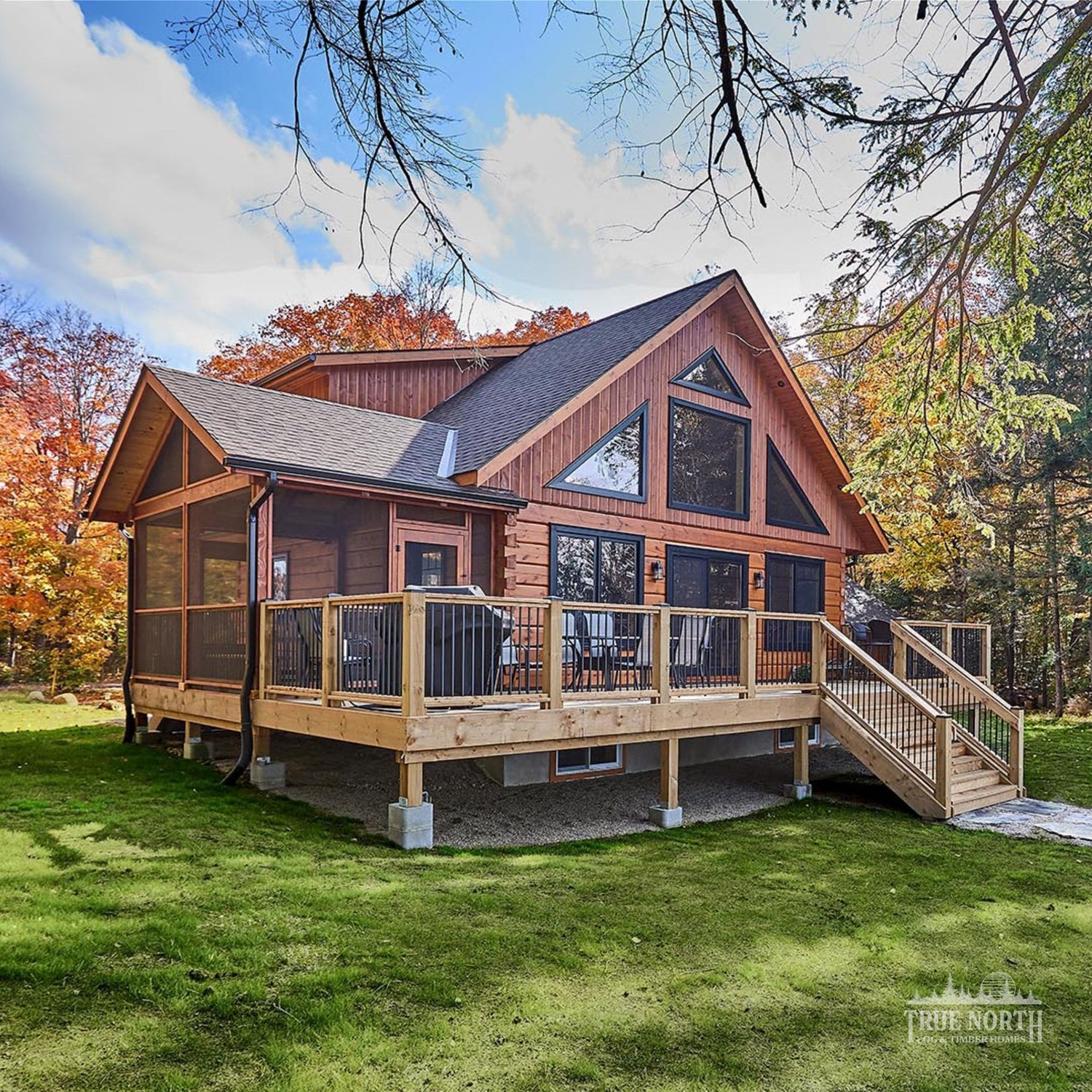 Arrowhead two-storey Canadian log home by True North Log Homes with cathedral ceilings and floor-to-ceiling windows - Link to Cabin Category