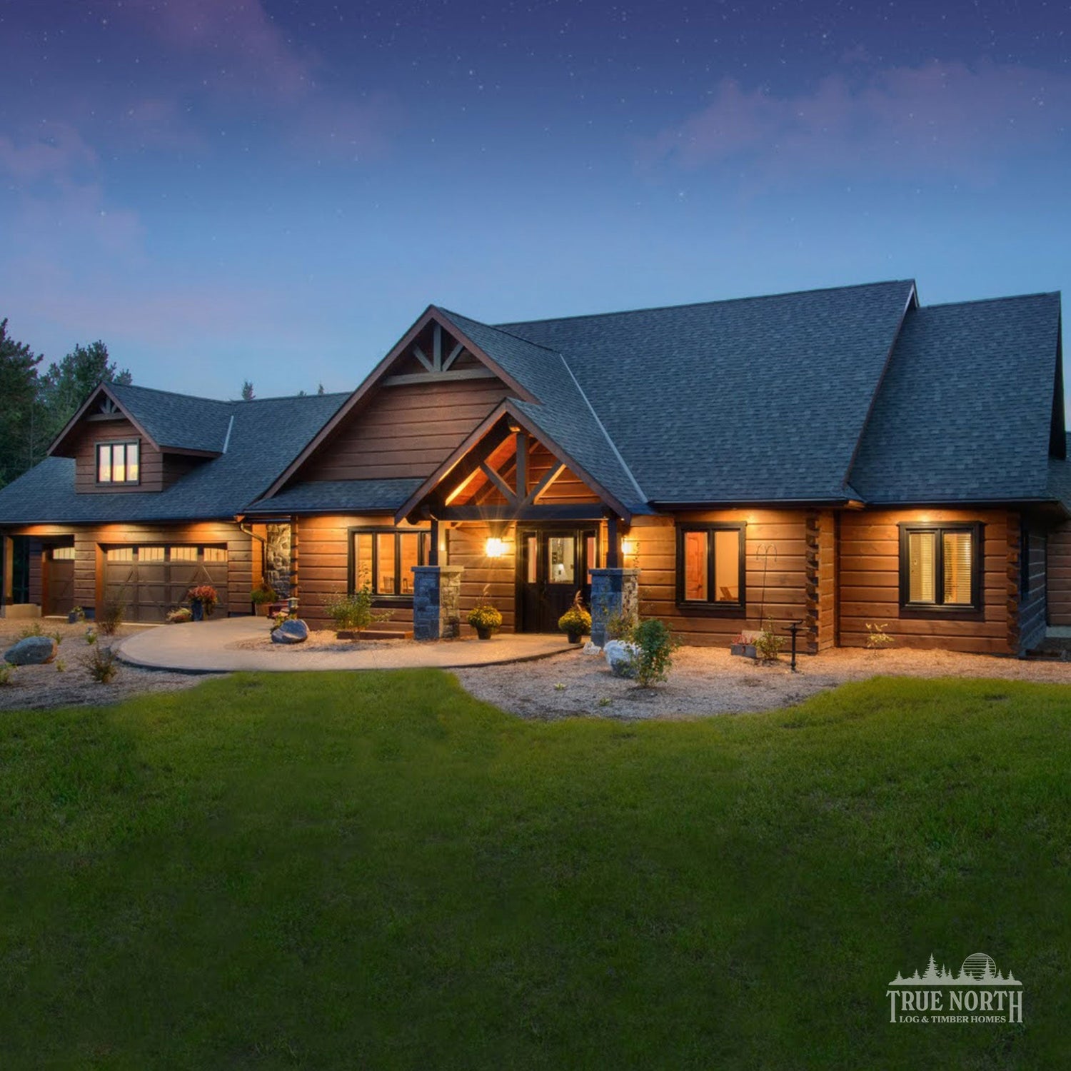 Luxury Canadian log home y True North Log Homes lit at dusk - Link to Residential Category