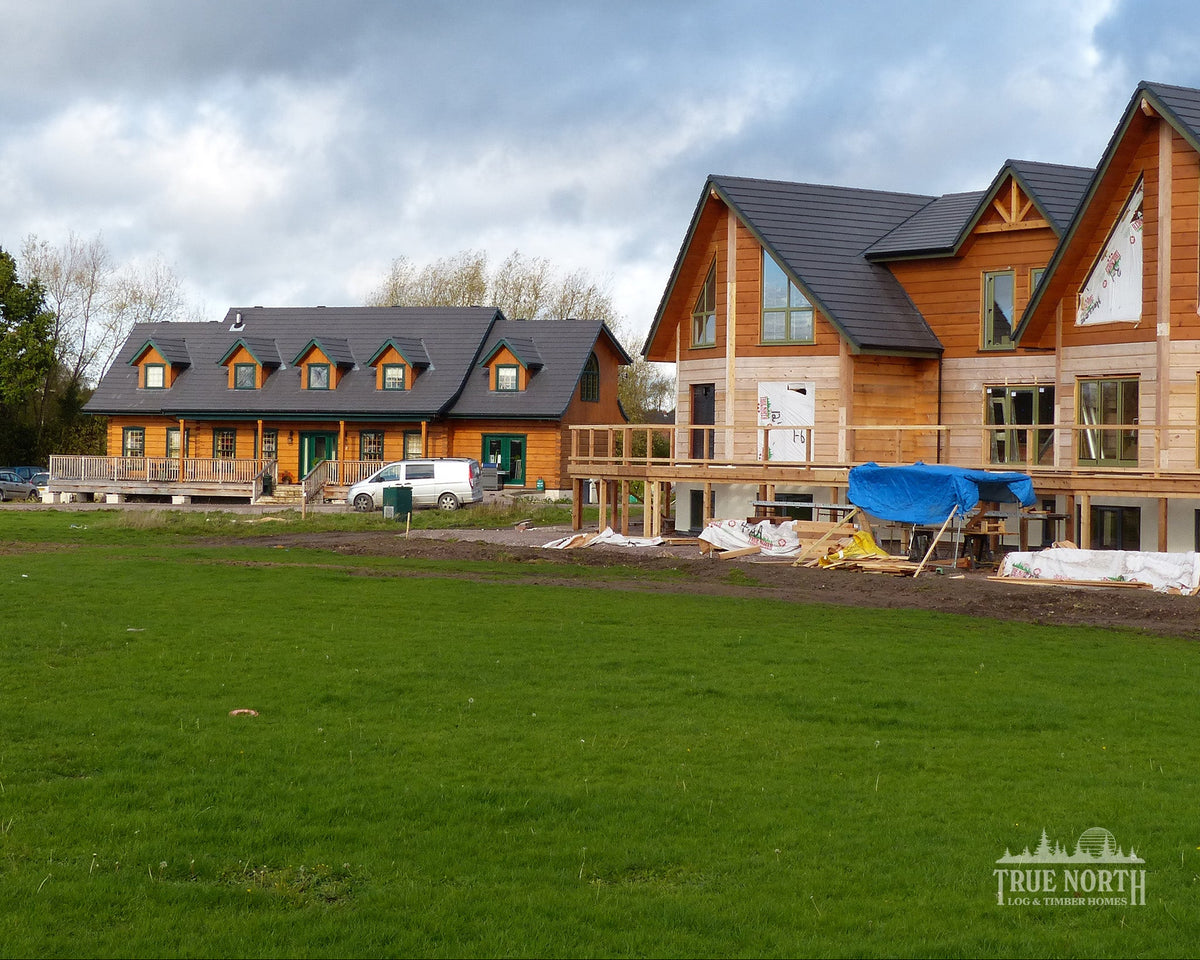 Louisburg traditional Canadian log home designed for family living in Derbyshire - With sister Alaskan in the foreground